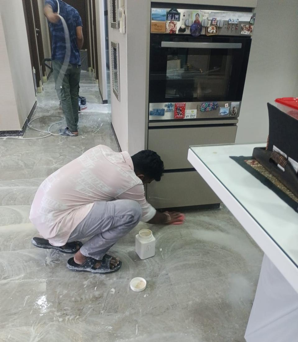 Technician applying marble polishing powder by hand at cabinet edges