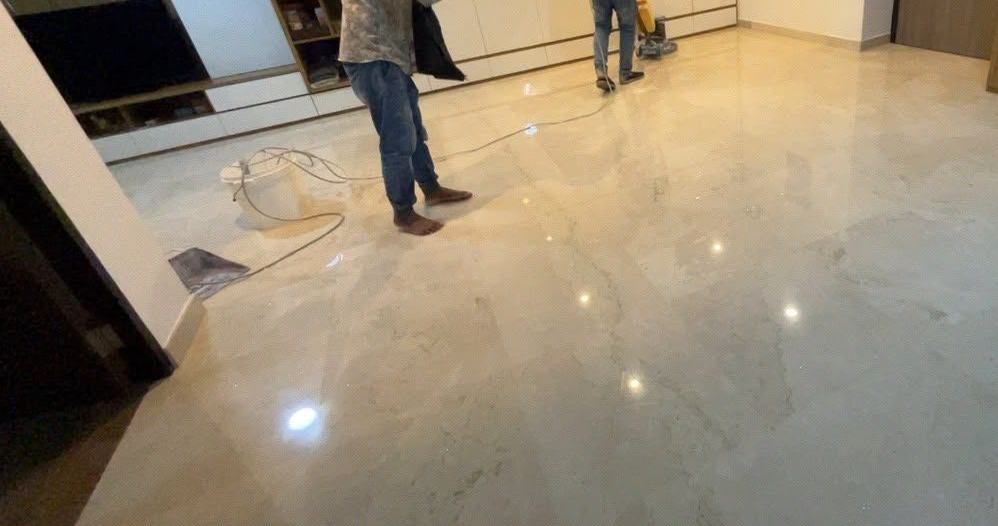 Technicians grinding a marble floor with a floor machine